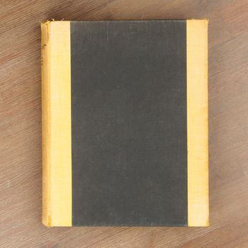 Old book isolated on a wooden table