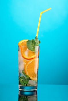 Mojito orange cocktail.on blue background. close up