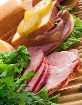 sandwiches with cheese and ham . food arrangement of meat, bread and vegetables