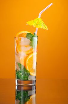 Mojito orange cocktail. on yellow background.