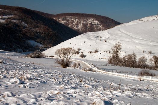 A lonely, snow-covered valley in winter