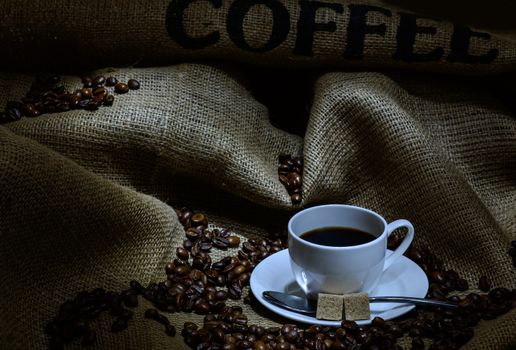 Coffee cup, beans and burlap. still life