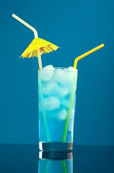 Blue hawaiian cold cocktail  closeup on blue background.