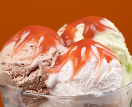 ice cream topped with syrup . closeup