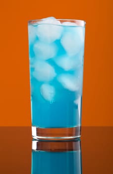 Blue hawaiian cold cocktail  closeup on yellow background 