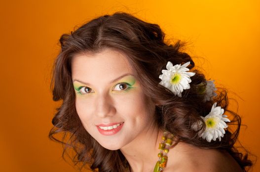 elegant fashionable woman with flowers  on yellow background 