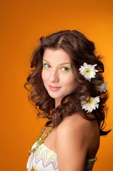 elegant fashionable woman with flowers  on yellow background 