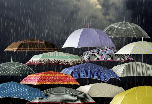 Dark stormy clouds and umbrellas