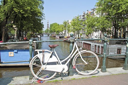 White bicycle in Amsterdam with the Westerkerk in the Netherlands