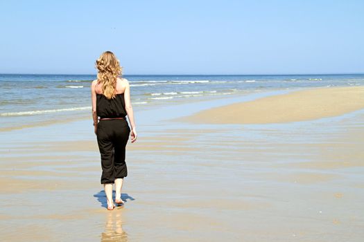 Beautiful young blonde woman at the beach