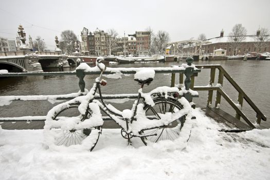 Snowy bicycle in Amsterdam city center the Netherlands