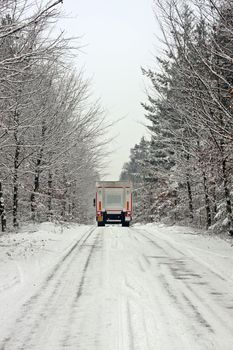 Truck driving in the snow in the countryside from the Netherlands