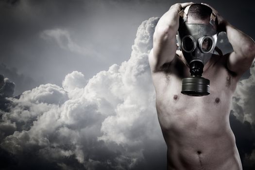 pollution concept: portrait of nude man in a gas mask