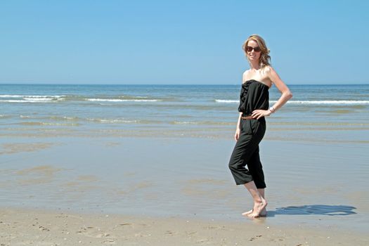 Beautiful blonde woman relaxing at the waterfront