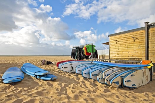 Surfboard and cloting at the beach from the north sea in the Netherlands