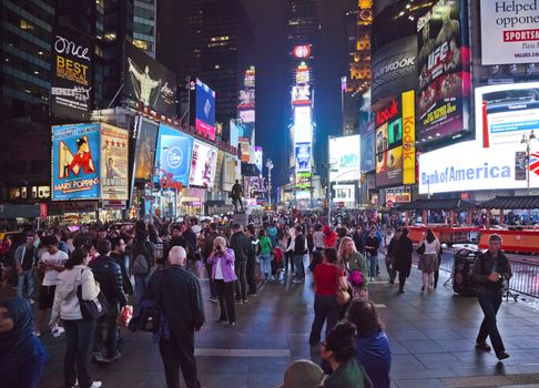 NEW YORK CITY - SEPT 28: Times Square, full of tourists from all the world's countries, featured with Broadway Theaters, Taxi Cabs and animated LED signs, is a symbol of New York City and the United States. September 28, 2012 in Manhattan, New York City