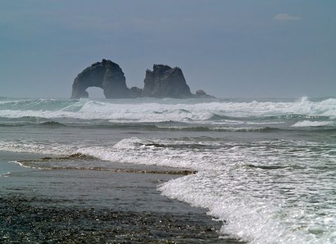 Arch Shaped Rock in the Ocean at the Beach