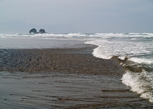 Arch Shaped Rock in the Ocean at the Beach