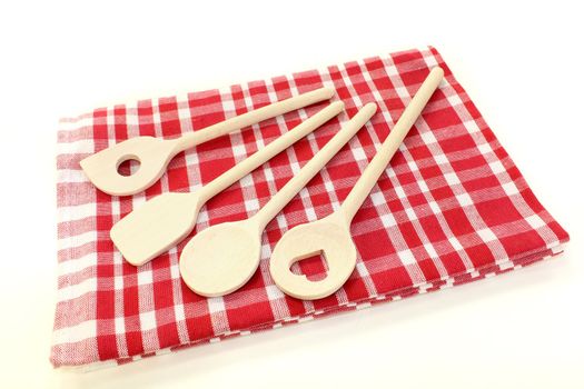 liight wooden cooking spoon on a checkered napkin