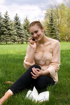 Woman relaxing in nature. Talking on the phone