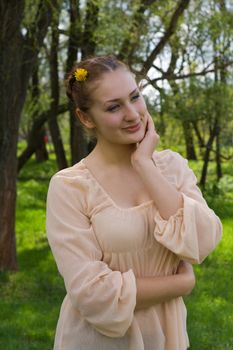 Portrait of a girl on the background of nature in spring