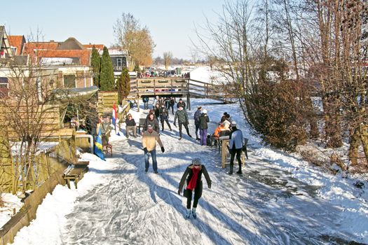 Ice skating in the countryside on a nice winter day in the Netherlands