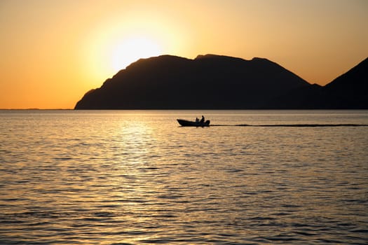 silhouette of a boat during the sunset