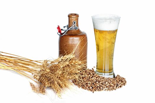 Still life with wheat, beer and a jar on a white background