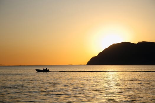 silhouette of a boat during the sunset