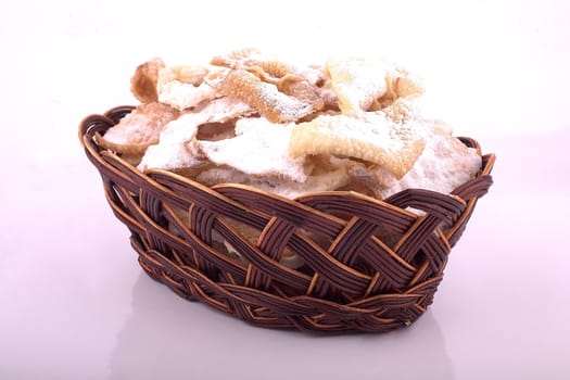 Cookie-crispies in a brown wicker vase on a light background