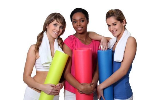 Young women going to yoga class together