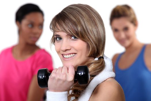 Pretty girl lifting a dumbbell