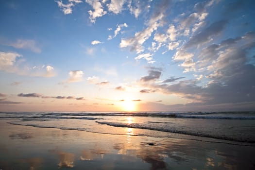 Beautiful cloudscape at the beach at sunset