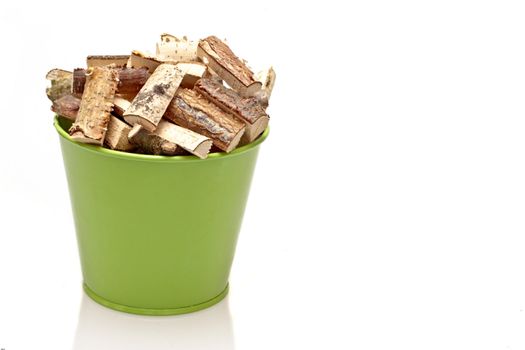 Green bucket full of fire wood blocks