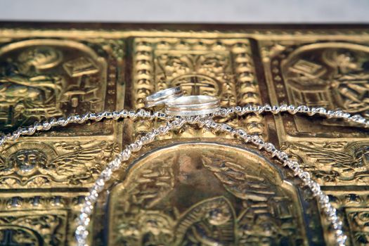 close up of wedding rings and crowns