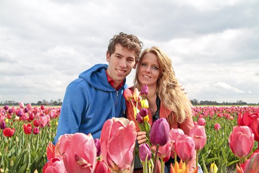 Young happy couple in the tulip fields from the Netherlands