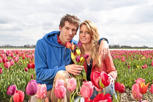 Young happy couple in the tulip fields from the Netherlands