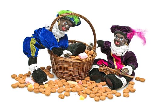 Two black piet with a basket full of gingernuts and sweets at santa claus feast at 5th of december in the Netherlands