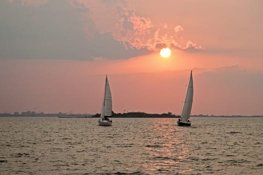 Sailing on the IJsselmeer at Pampus in the Netherlands with sunset