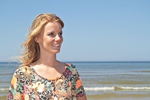 Beautiful young blonde woman at the beach