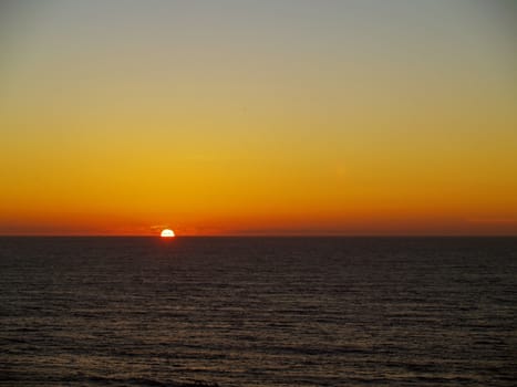 Golden Orange Sunset in a Clear Sky Over the Ocean