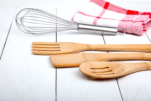 Wooden kitchen set with tea towel, on wooden white background.