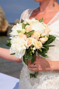 Bride holding groom's hand and the bouquet at their wedding