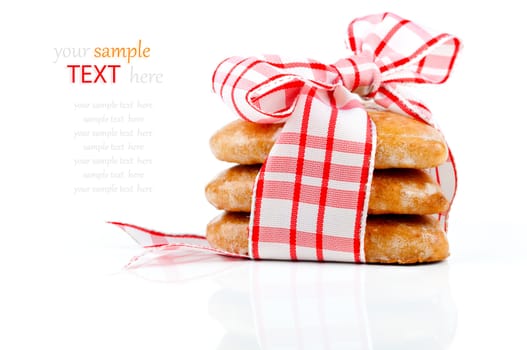 Cookies-hearts connected by a red tape on a white background