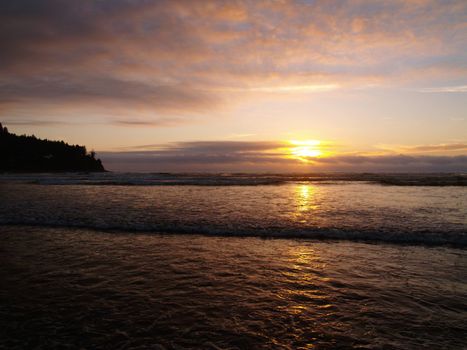 Beautiful Sunset Over the Ocean wth Waves in the Foreground