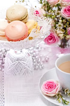 traditional delicious sweet dessert macarons and coffee on table