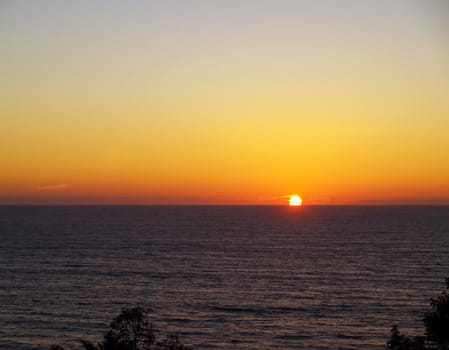 Golden Orange Sunset in a Clear Sky Over the Ocean