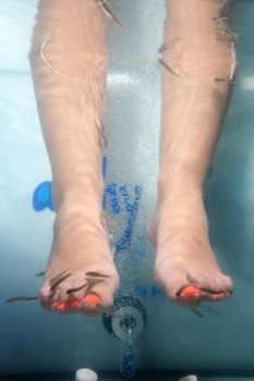 close-up of feet taking care at fish spa