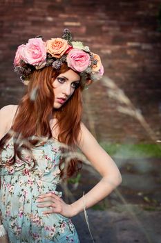 beautfiul woman outdoor in summer with flowers on head romantic fashion