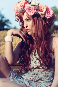 beautfiul woman outdoor in summer with flowers on head romantic fashion